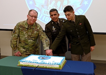 From left, the NHANG's oldest guardsman, Chief Master Sgt. Alfred Orsini, NH Adjutant Gen. David Mikolaities, and the NHARNG's youngest guardsman, Pvt. Waleed Shahin, cut a cake with a ceremonial sword during the Guard's 386th birthday celebration and annual awards ceremony Dec. 13, 2022, at the Edward Cross Training Complex in Pembroke.