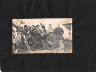 USRCS Sailors pose with their mascot dog.