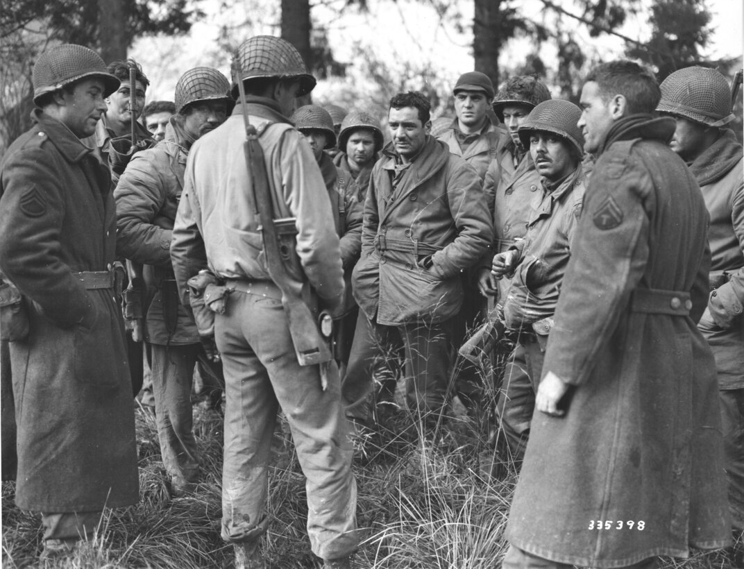 Members of the 28th Infantry Division Band and Quartermaster Company who stayed and held Germans in Wiltz, Luxembourg, on Dec. 20, 1944. (U.S. Army Signal Corps photo)