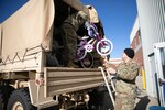 1st Lt. Chris Lind with the 197th Field Artillery Brigade (rear detachment) and 1st Sgt. Paul Emond, senior enlisted advisor of NHNG's 744th Forward Support Company, 3rd Battalion, 197th Field Artillery Regiment, load donated bikes into a light medium tactical vehicle for Operation Santa Claus in Concord on Dec. 13, 2022.