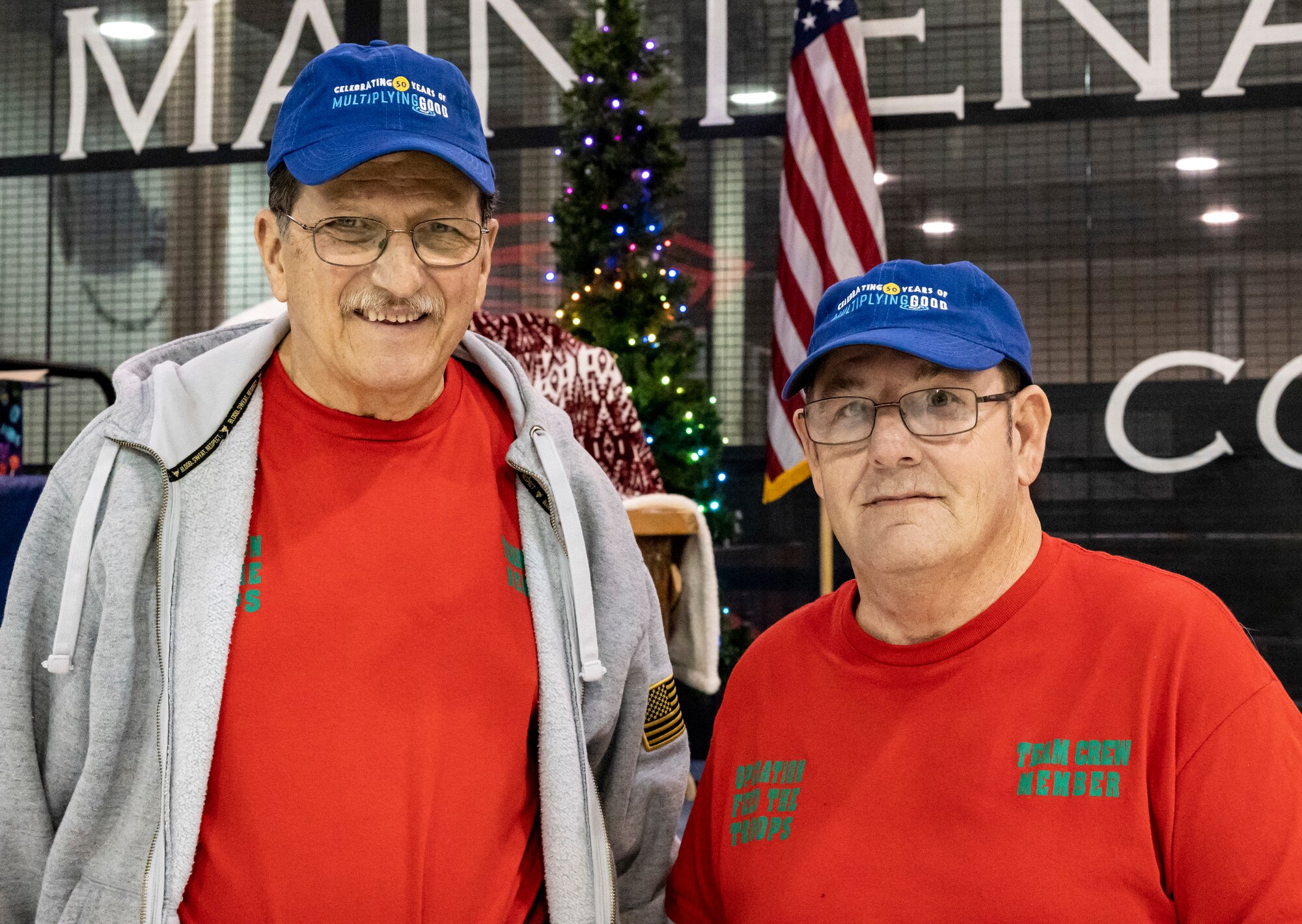 Bob Reese, left, and Rene Baldrich, right, founders and organizers of Operation Feed the Troops, pose for a photo during OFT on Dover Air Force Base, Delaware, Dec. 14, 2022. Reese and Baldrich are U.S. Air Force veterans with more than 70 years of combined service, and have been feeding Dover Airmen during the holidays for the last 20 years. (U.S. Air Force photo by Senior Airman Stephani Barge)