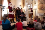 Gov. Jared Polis reads "How NORAD Saved Christmas," at the Governor's Residence, Denver, to children of deployed Colorado National Guard members Dec. 3, 2019. By invitation of the Colorado governor and the State of Colorado, families of deployed CONG members are invited to an annual holiday gathering at the Boettcher Mansion. (U.S. Army National Guard photo by Staff Sgt. Joseph D. Labutka)