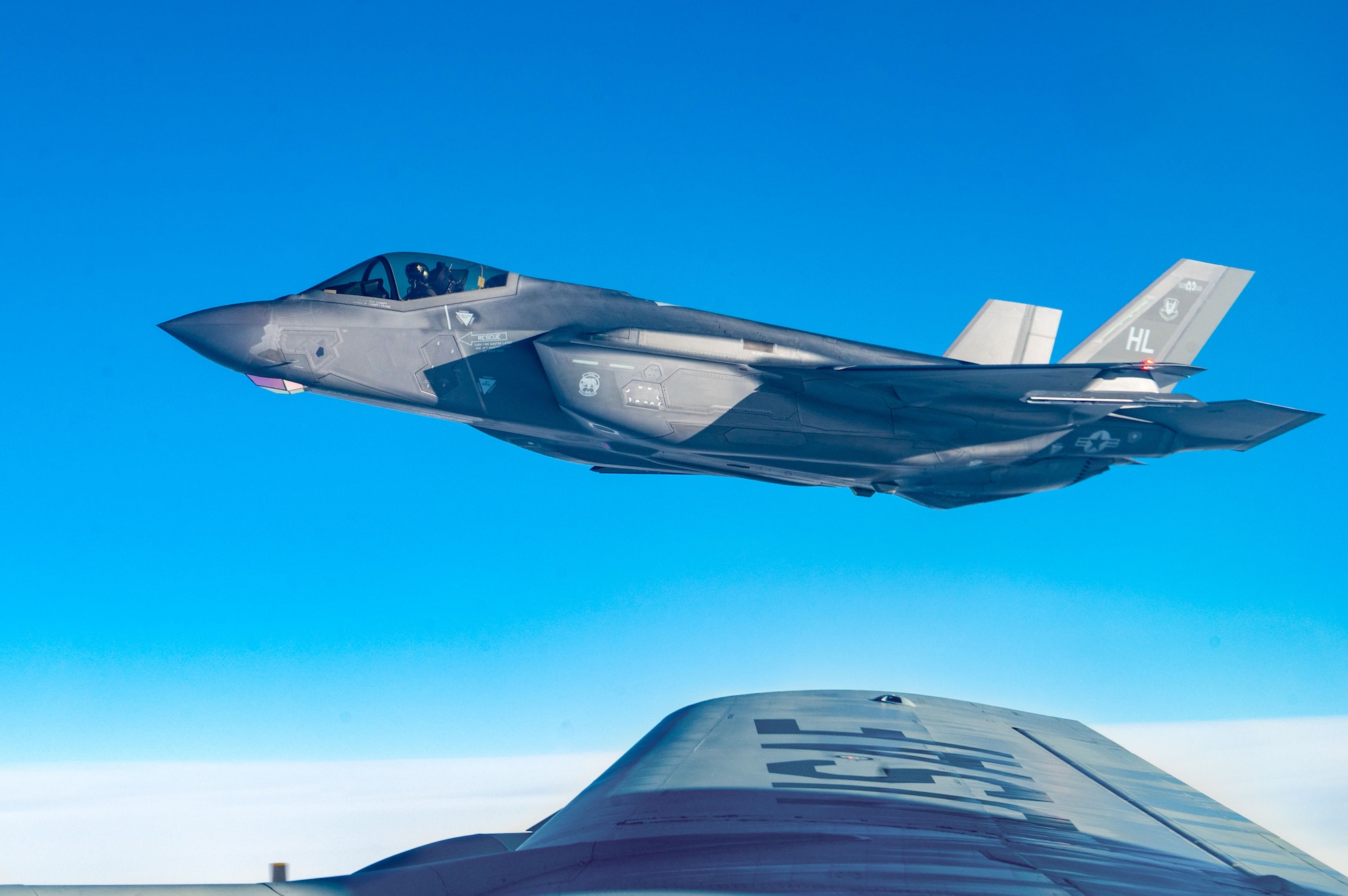 A U.S. Air Force F-35 Lightning II from Hill Air Force Base flies in formation with a KC-135 Stratotanker from Fairchild Air Force Base after being refueled, Dec. 12, 2022. The KC-135 is the core of air refueling, and is responsible for extending the Air Force’s global reach. (U.S. Air Force photo by Airman 1st Class Stassney Davis)