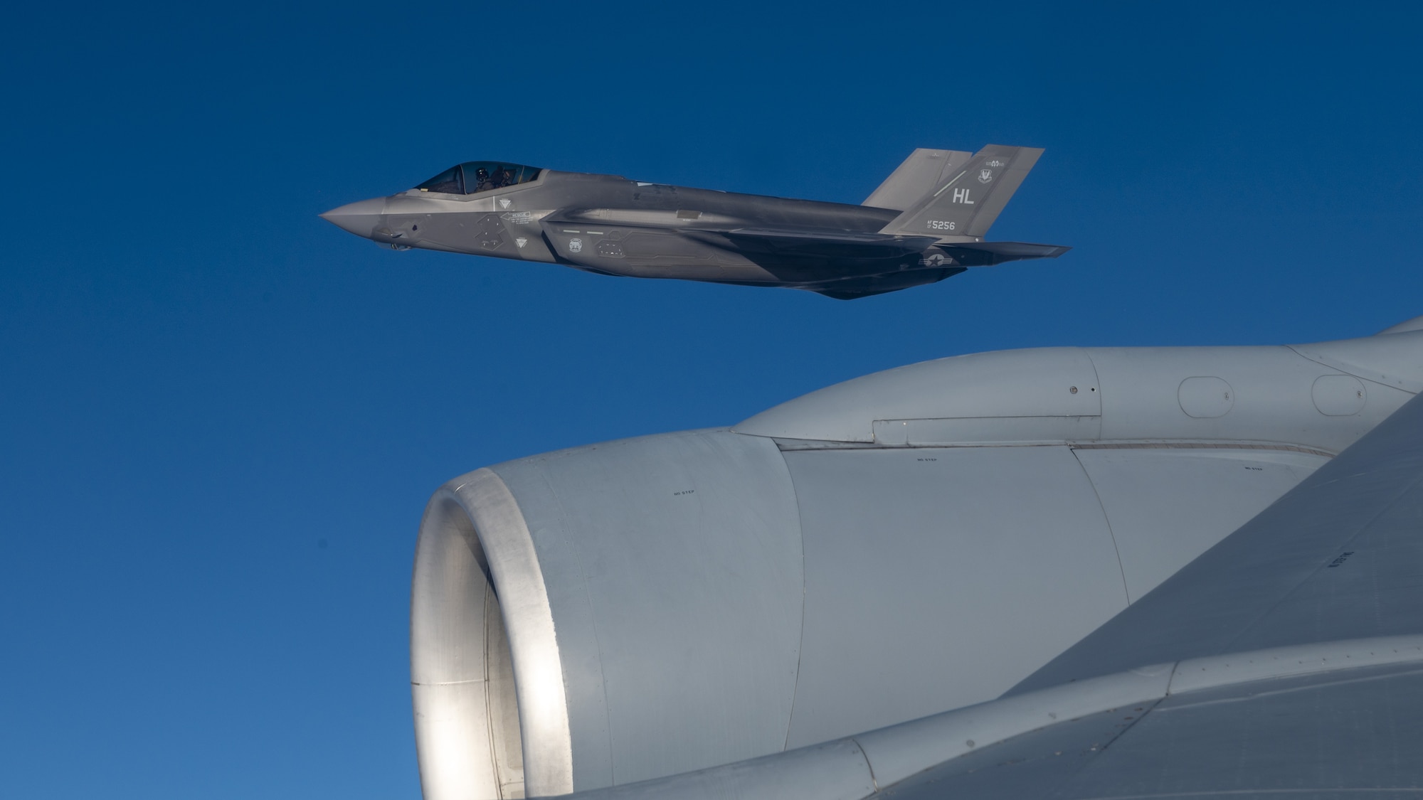 A U.S. Air Force F-35 Lightning II from Hill Air Force Base flies in formation with a KC-135 Stratotanker from Fairchild Air Force Base during a routine air refueling mission Dec. 12, 2022. The F-35 pilots and KC-135 crew conducted the training to enhance their readiness to execute missions anywhere, anytime. (U.S. Air Force photo by Staff Sgt. Lawrence Sena)