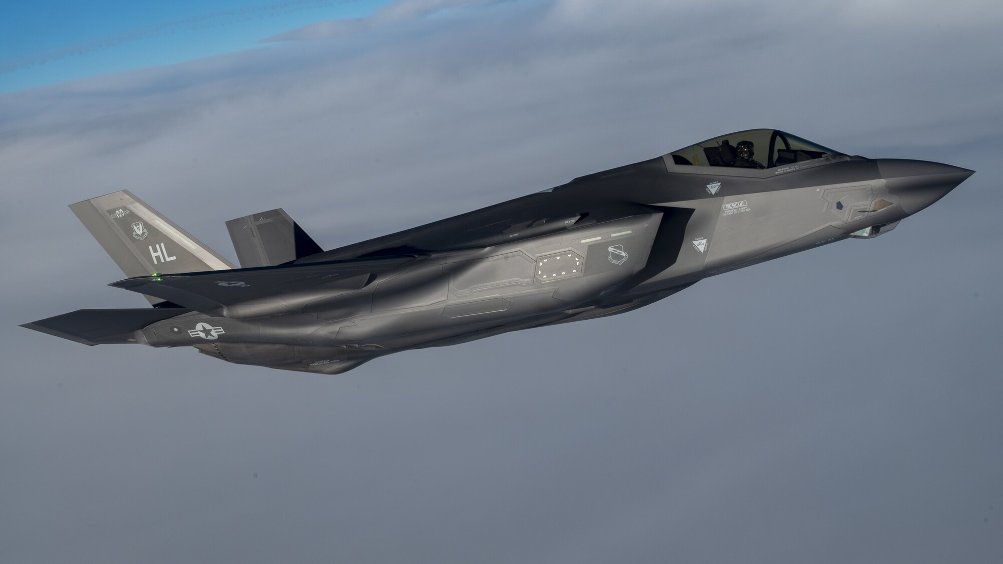 A U.S. Air Force F-35 Lightning II from Hill Air Force Base flies in formation with a KC-135 Stratotanker from Fairchild Air Force Base during a routine air refueling mission Dec. 12, 2022. The F-35 pilots and KC-135 crew conducted the training to enhance their readiness to execute missions anywhere, anytime. (U.S. Air Force photo by Staff Sgt. Lawrence Sena)