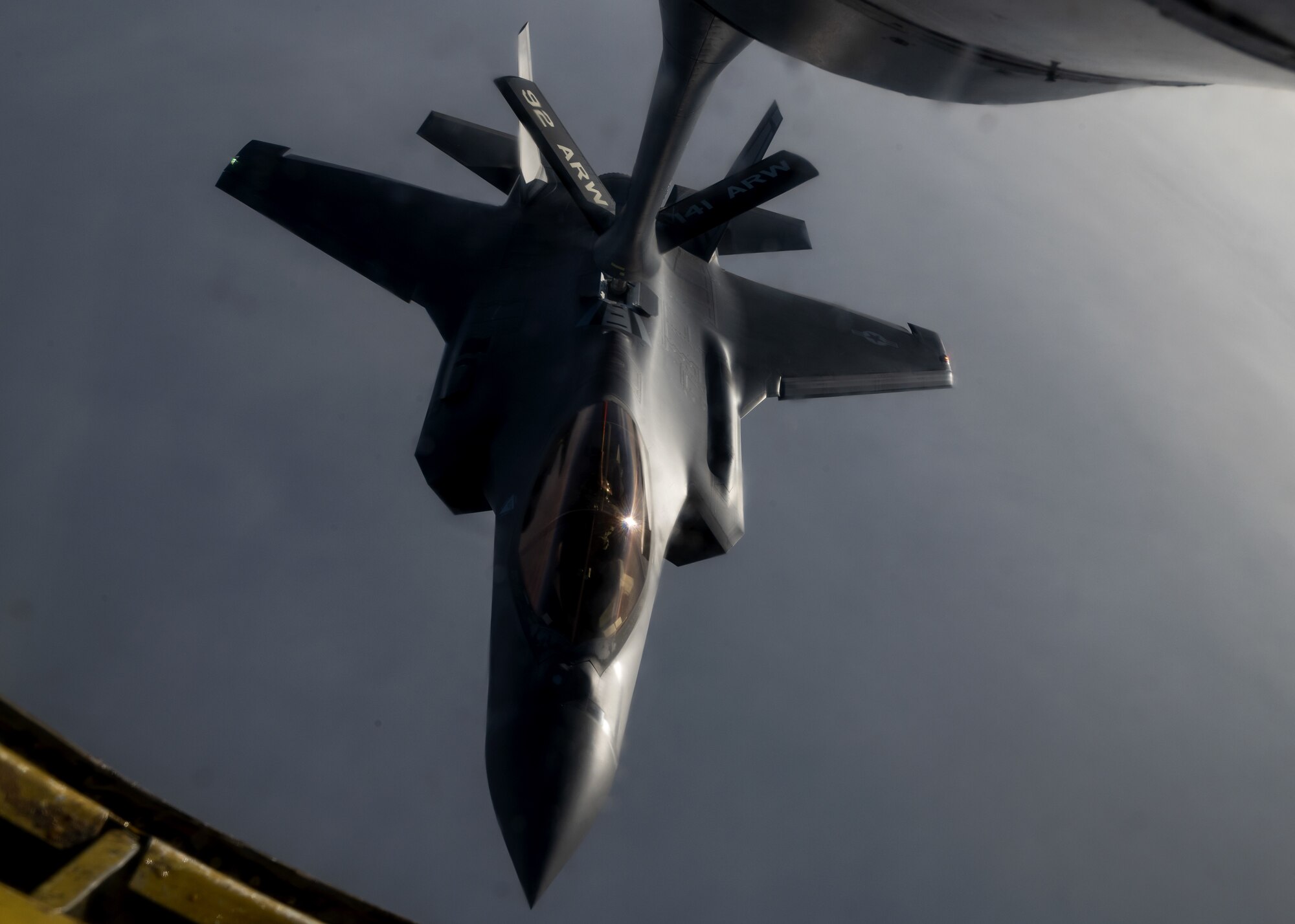 A U.S. Air Force F-35 Lightning II from Hill Air Force Base is refueled by a KC-135 Stratotanker from Fairchild Air Force Base during a routine air refueling mission Dec. 12, 2022. The F-35 pilots and KC-135 crew conducted the training to enhance their readiness to execute missions anywhere, anytime. (U.S. Air Force photo by Staff Sgt. Lawrence Sena)