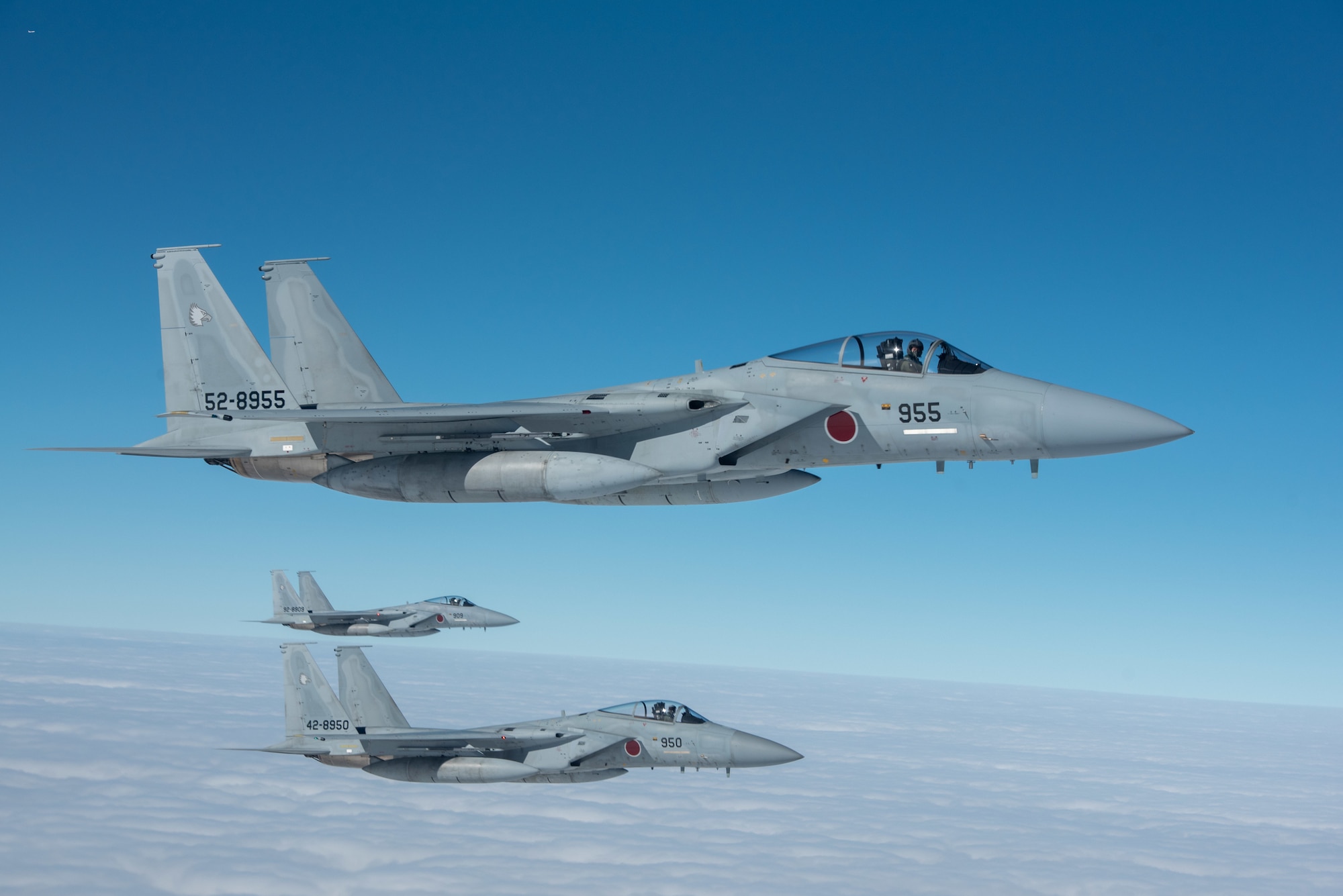Three Japan Air Self-Defense Force F-15J Eagles fly alongside a U.S. Air Force KC-135 Stratotanker