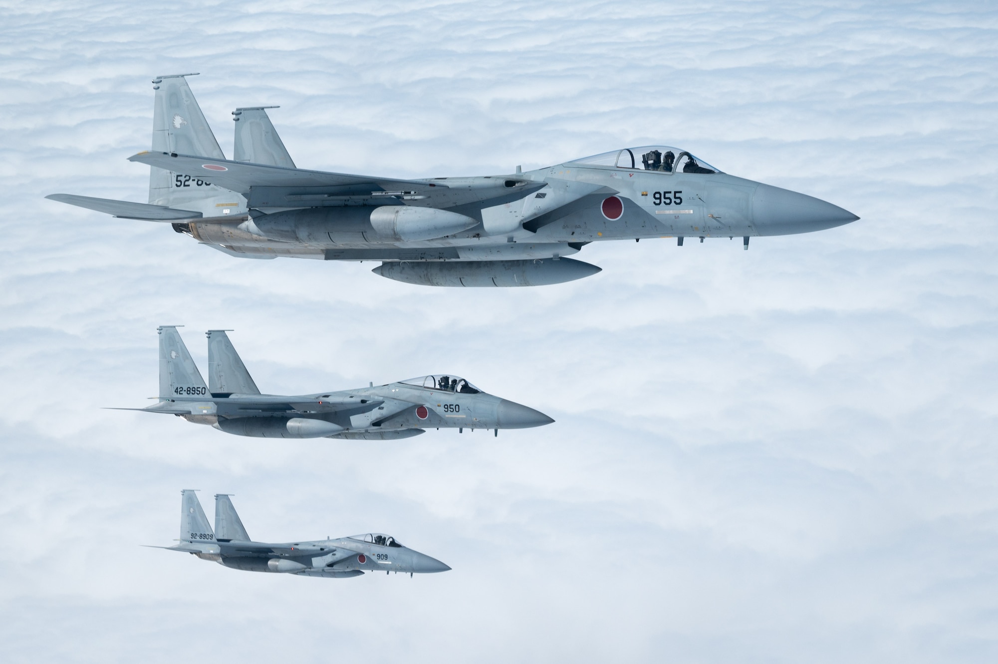 Japan Air Self-Defense Force F-15J Eagles fly alongside a U.S. Air Force KC-135 Stratotanker