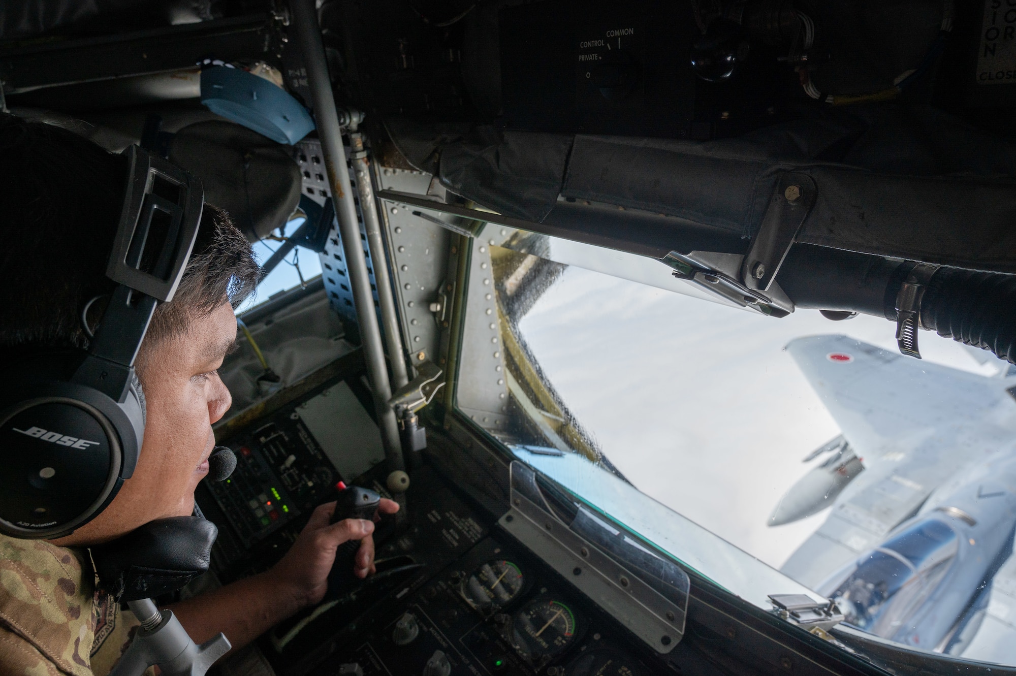 A U.S. Airman refuels a Japan Air Self-Defense Force F-15J Eagle