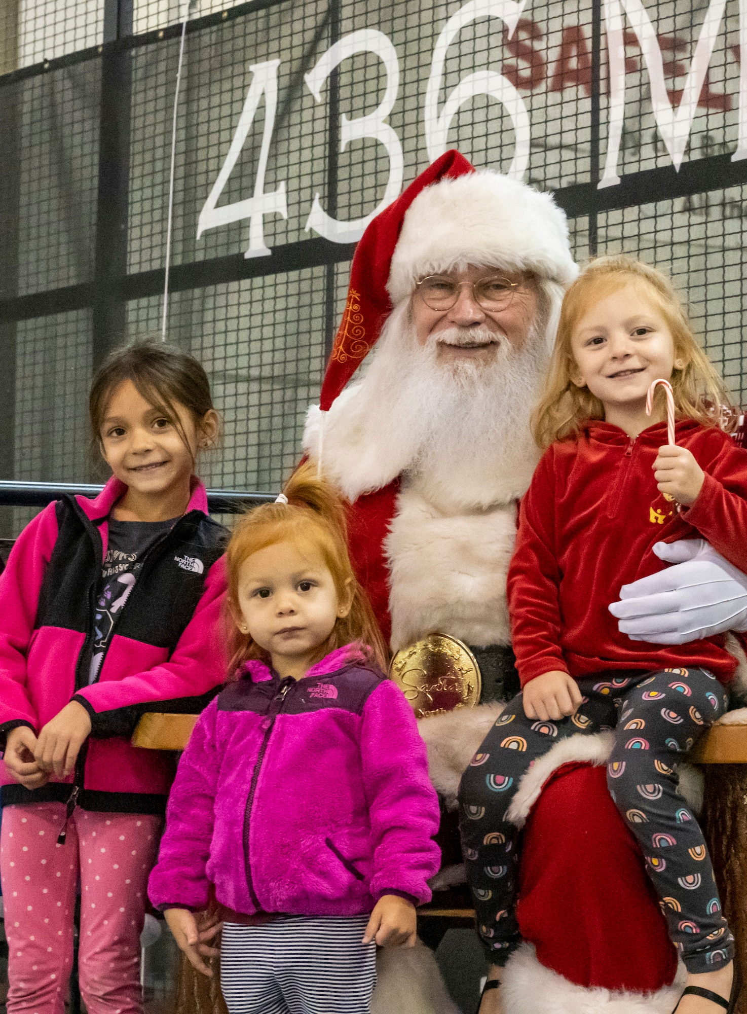 Santa Claus takes photos with the children of Team Dover members during Operation Feed the Troops on Dover Air Force Base, Delaware, Dec. 14, 2022. The 20th annual OFT featured a traditional holiday dinner, desserts, live music and a visit from Santa Claus. (U.S. Air Force photo by Senior Airman Stephani Barge)