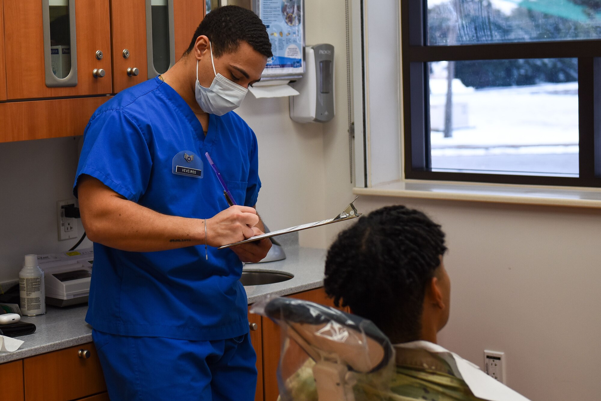 Senior Airman Malik Veveiros, 8th Operational Medical Readiness Squadron dental technician, reviews the chart of a patient at Kunsan Air Base, Republic of Korea, Dec. 14, 2022. Dental care patients are usually left with advice on how to maintain or improve their overall oral health. (U.S. Air Force Photo by Tech. Sgt. Timothy Dischinat)
