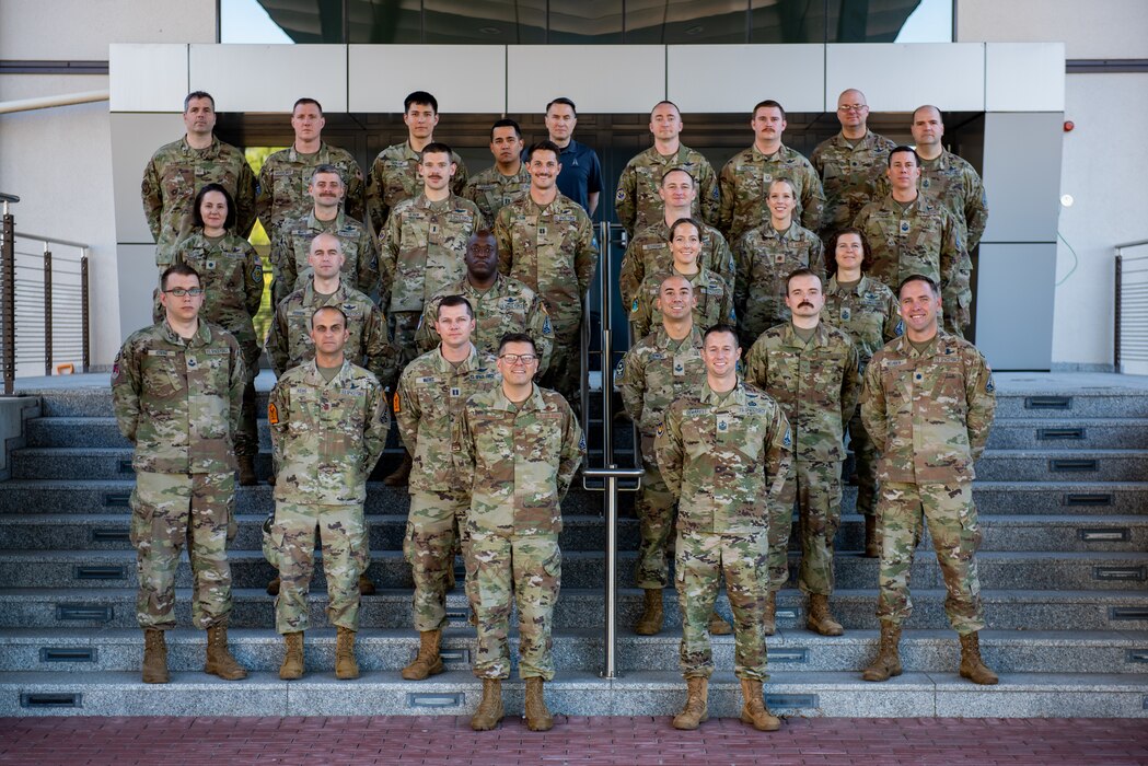 The USAFE-AFAFRICA Space Force team poses for a photo in front of their building on Ramstein Air Base, Germany.