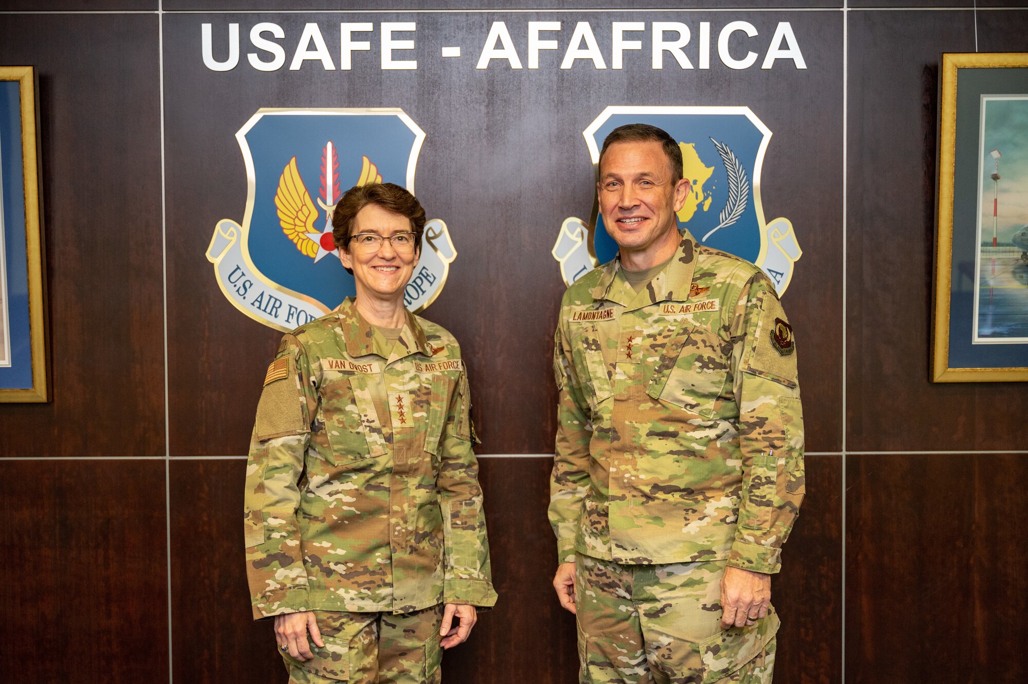 Gen. Jacqueline Van Ovost, U.S. Transportation Command commander and Lt. Gen. John Lamontagne, U.S. Air Forces in Europe and Air Forces Africa deputy commander pose for a photo during a headquarters tour at Ramstein Air Base, Germany, Dec. 16, 2022.