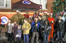 Army children sing with commanding general and command sergeant major