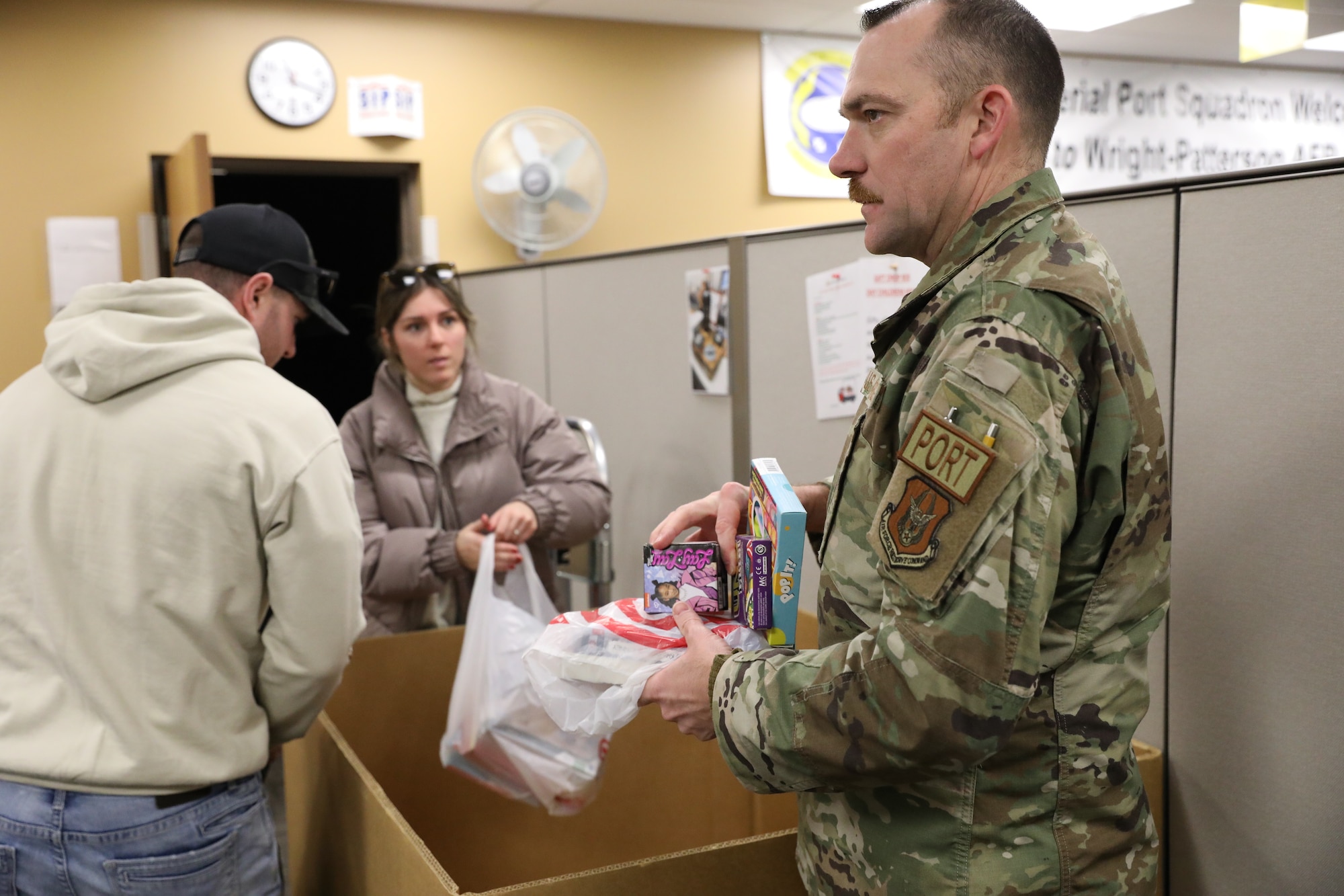 Senior Master Sgt. Brian Anders, right, 87th Aerial Port Squadron assistant manager and Staff Sgt. Kelly Sloan, 87th APS special handling representative, collect donated toys for delivery to a local children’s hospital.