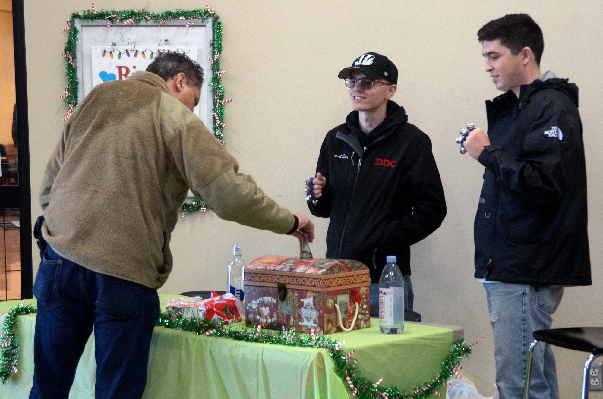 Senior Airmen Royce Bridstrup (center) and Andrew Fultz (right), 445th Communications Element client system technicians, ring bells as volunteers at the annual Ring the Bell event for the Wright-Patterson Air Force Base First Sergeant Council’s Operation Warm Heart at the Wright-Patterson Air Force Base commissary, Dec. 3, 2022. (U.S. Air Force photo/Staff Sgt. Darrell Sydnor II)
