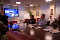 Lori Whitmire, a Naval History and Heritage Command historian, gives a presentation to Commander, Carrier Strike Group (CSG) 4 staff members.