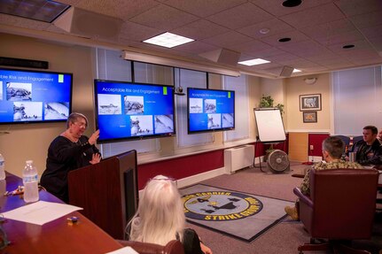 Lori Whitmire, a Naval History and Heritage Command historian, gives a presentation to Commander, Carrier Strike Group (CSG) 4 staff members.