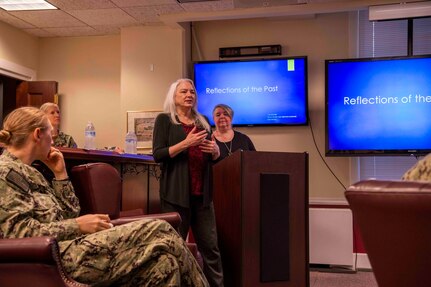 Lori Whitmire, a Naval History and Heritage Command historian, gives a presentation to Commander, Carrier Strike Group (CSG) 4 staff members.