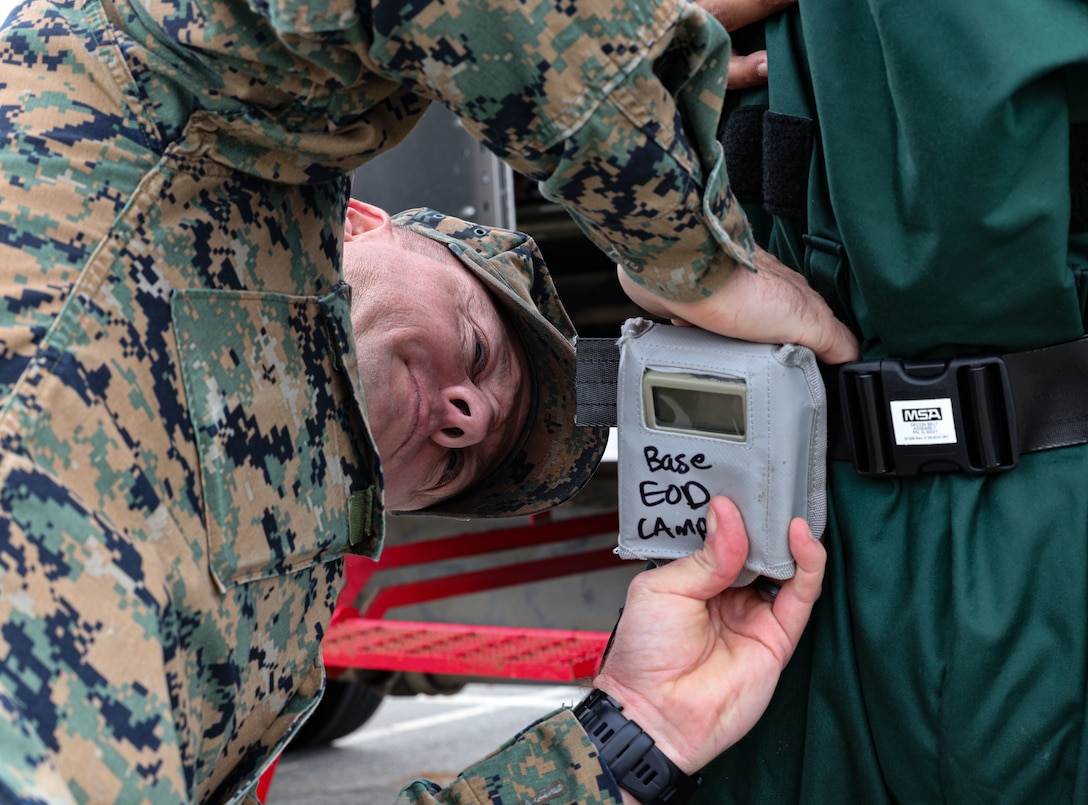 U.S. Marine Corps Capt. Jacky Brewer, left, an explosive ordnance disposal officer in charge with Headquarters and Service Company, Headquarters and Support Battalion, Marine Corps Base Camp Pendleton, helps prepare Gunnery Sgt. Jeffrey Bright Jr., an explosive ordnance disposal technician with Headquarters and Service Company, Headquarters and Support Battalion, Marine Corps Base Camp Pendleton during a Chemical, Biological, Radiological, Nuclear training event on Camp Pendleton, California, Dec. 06, 2022. The CBRN training was conducted in order to strengthen interoperability between Camp Pendleton first responders.