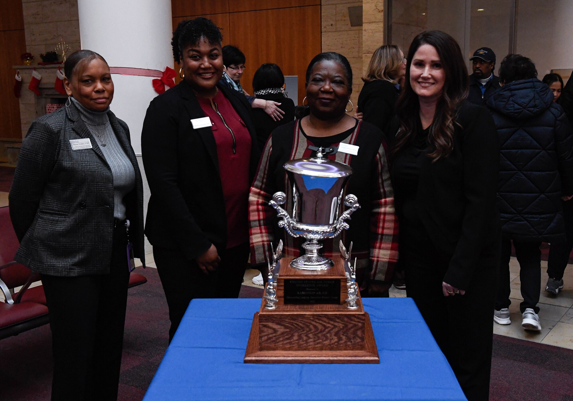 The 786th Force Support Squadron Kaiserslautern Military Community lodging team poses with the 2022 Air Force Innkeeper Award at Ramstein Air Base, Germany, Dec. 12, 2022. KMC lodging serves as the second largest Air Force lodging operation. (U.S. Air Force photo by Airman 1st Class Kaitlyn Oiler)