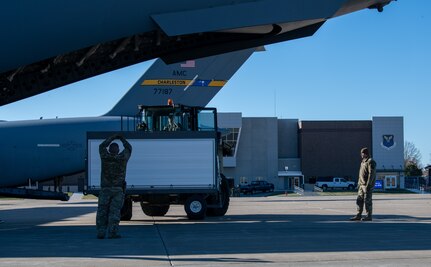 Airmen assigned to the 437th Airlift Wing and 509th Bomb Wing load equipment on to C-17 Globemaster III