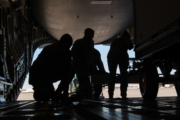 Airmen assigned to the 437th Airlift Wing and 509th Bomb Wing load equipment on to C-17 Globemaster III