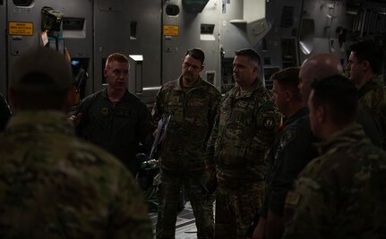 Airmen assigned to the 15th Airlift Squadron are given a safety brief before they refuel a B-2 Bomber from a C-17