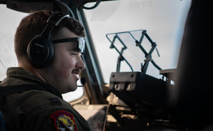 a pilot assigned to the 15th Airlift Squadron, checks his instruments