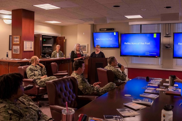 Lori Whitmire, a Naval History and Heritage Command historian, gives a presentation to Commander, Carrier Strike Group (CSG) 4 staff members.