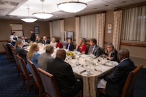 BOARD MEMBERS AROUND DINNER TABLE