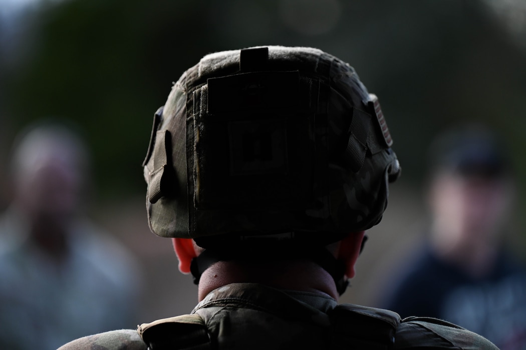 An Airman stands in a group.