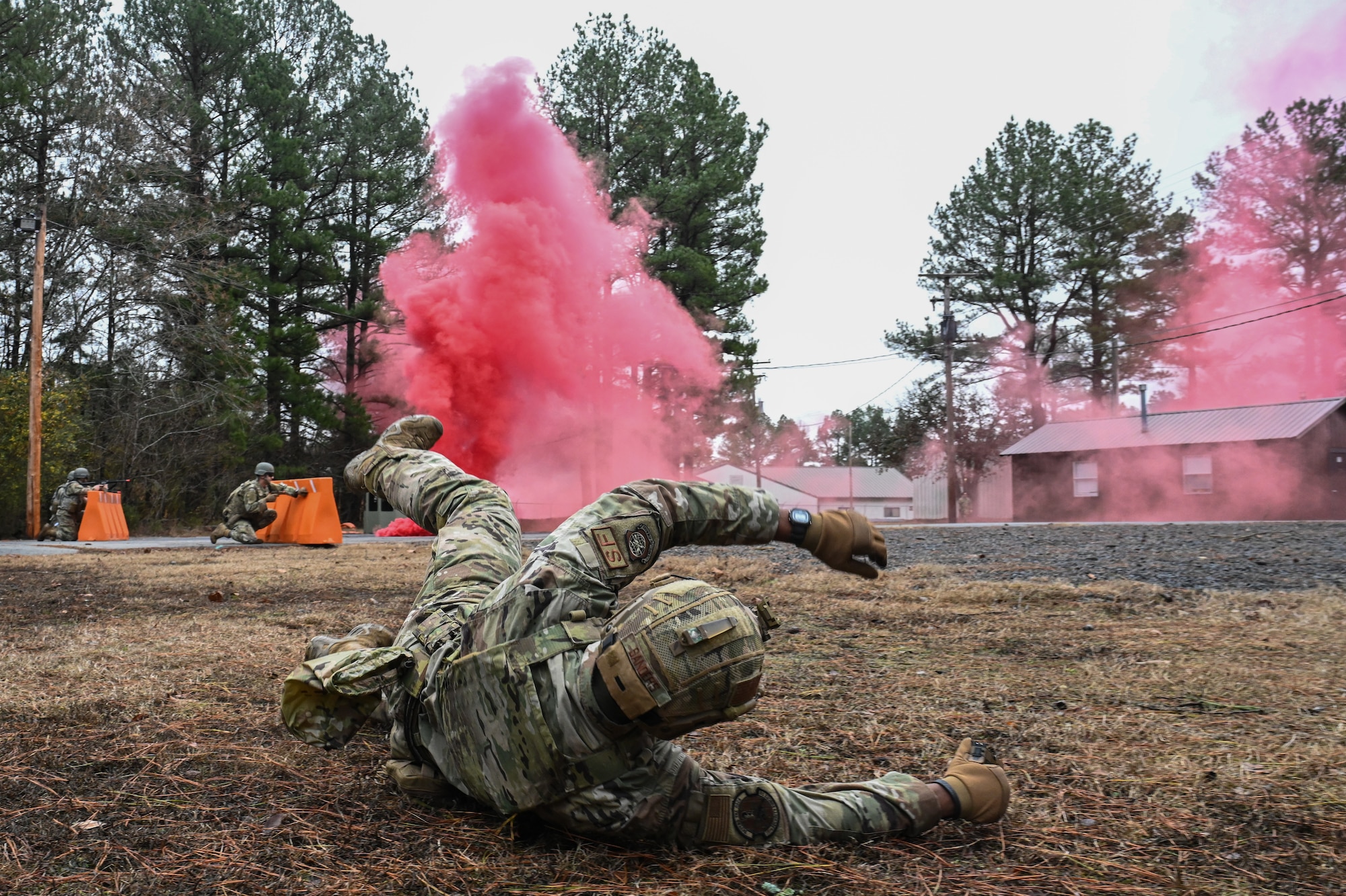 An Airman falls to the ground.