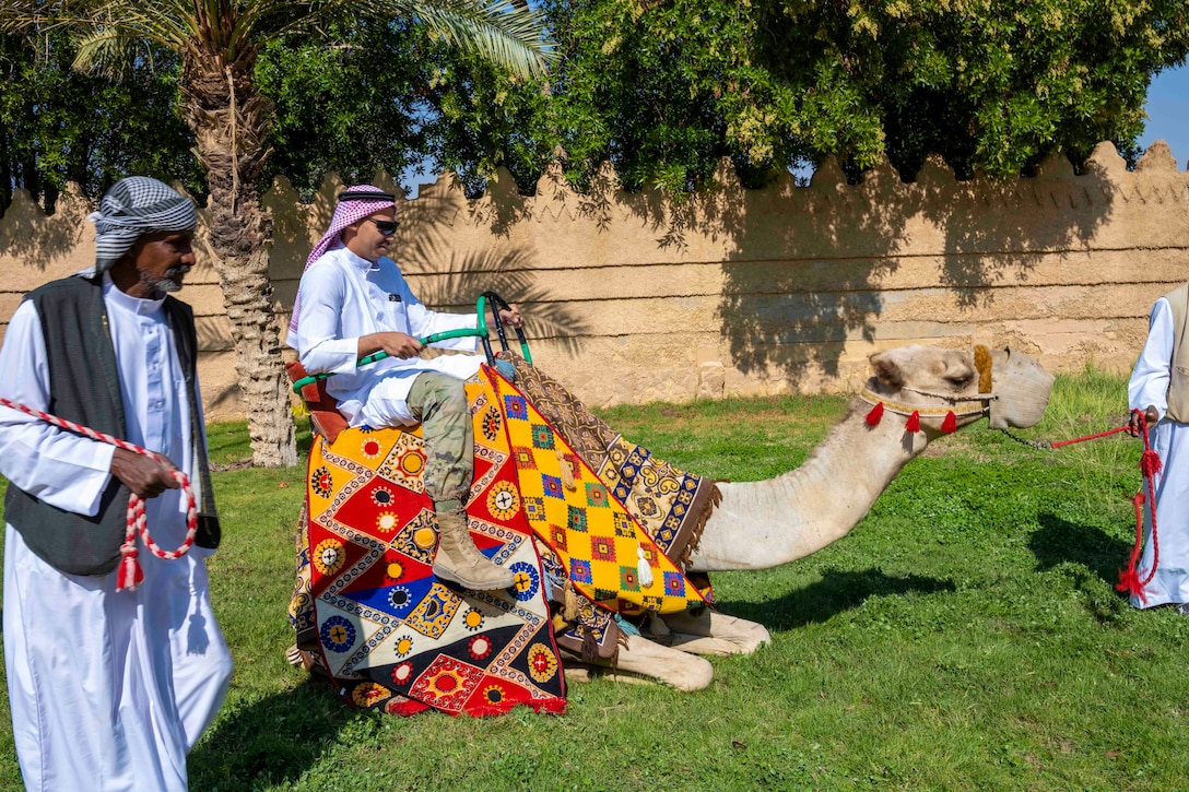 A soldier rides a camel.