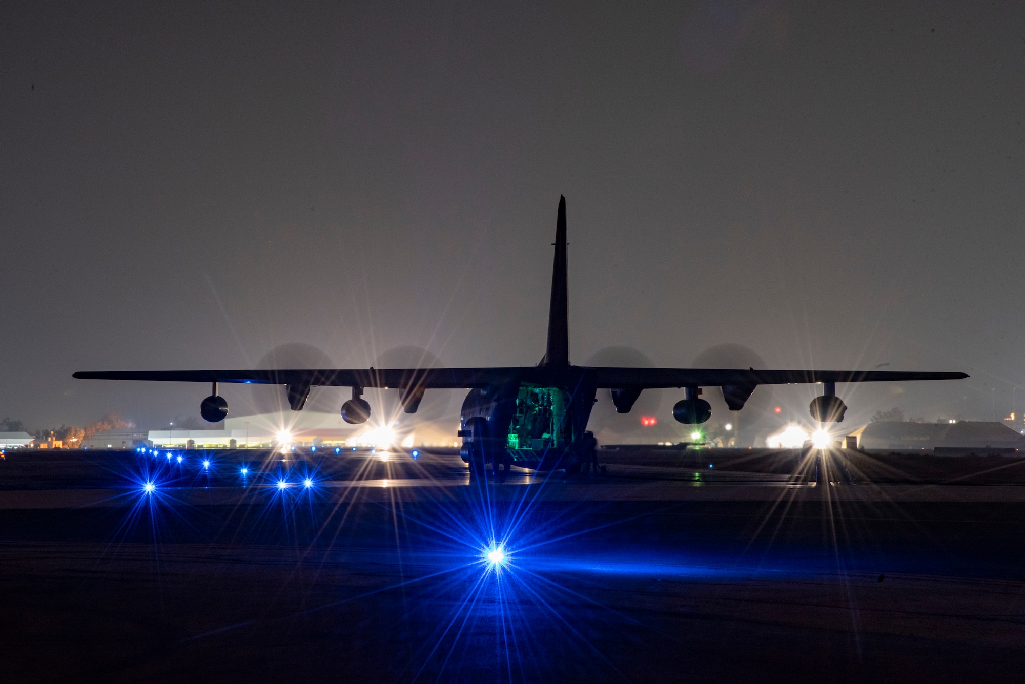 A 26th Expeditionary Rescue Squadron HC-130J Combat King II lands on a flight line at an undisclosed location, Southwest Asia, Dec. 10, 2022, as part of a Forward Arming and Refueling Point mission with an MQ-9 Reaper assigned to the 361st Expeditionary Attack Squadron.  (U.S. Air Force photo by: Tech. Sgt. Jim Bentley)