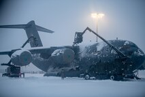 Airmen assigned to the 3rd Maintenance Squadron de-ice a C-17 Globemaster III