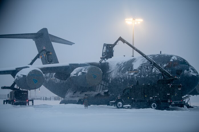Airmen assigned to the 3rd Maintenance Squadron de-ice a C-17 Globemaster III
