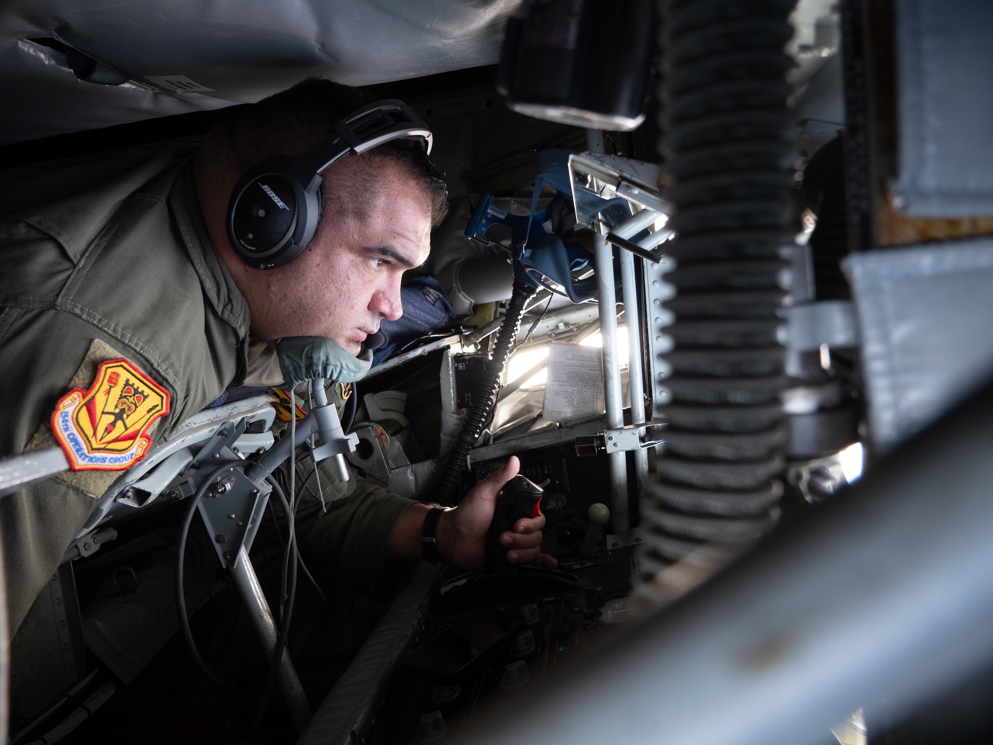 U.S. Air Force Senior Master Sgt. Noa Morse, 203rd Air Refueling Squadron boom operator, delivers fuel to Royal Australian Air Force aircraft December 8, 2022, near the coast of Oahu, Hawaii.