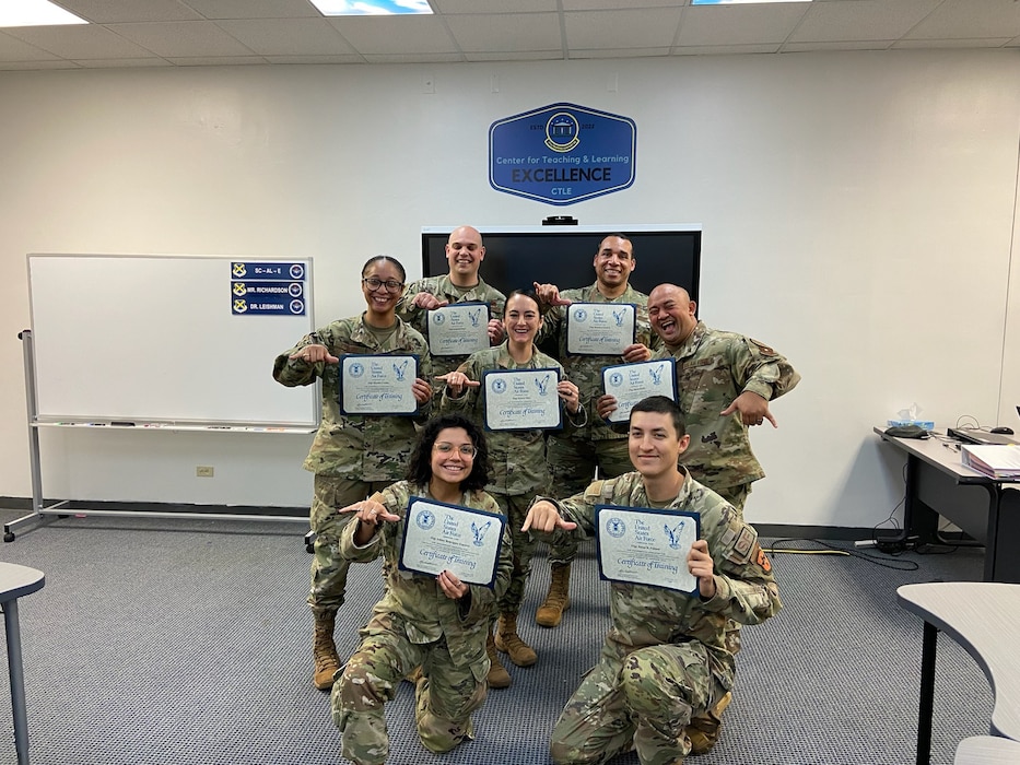 A group of people holding certificates