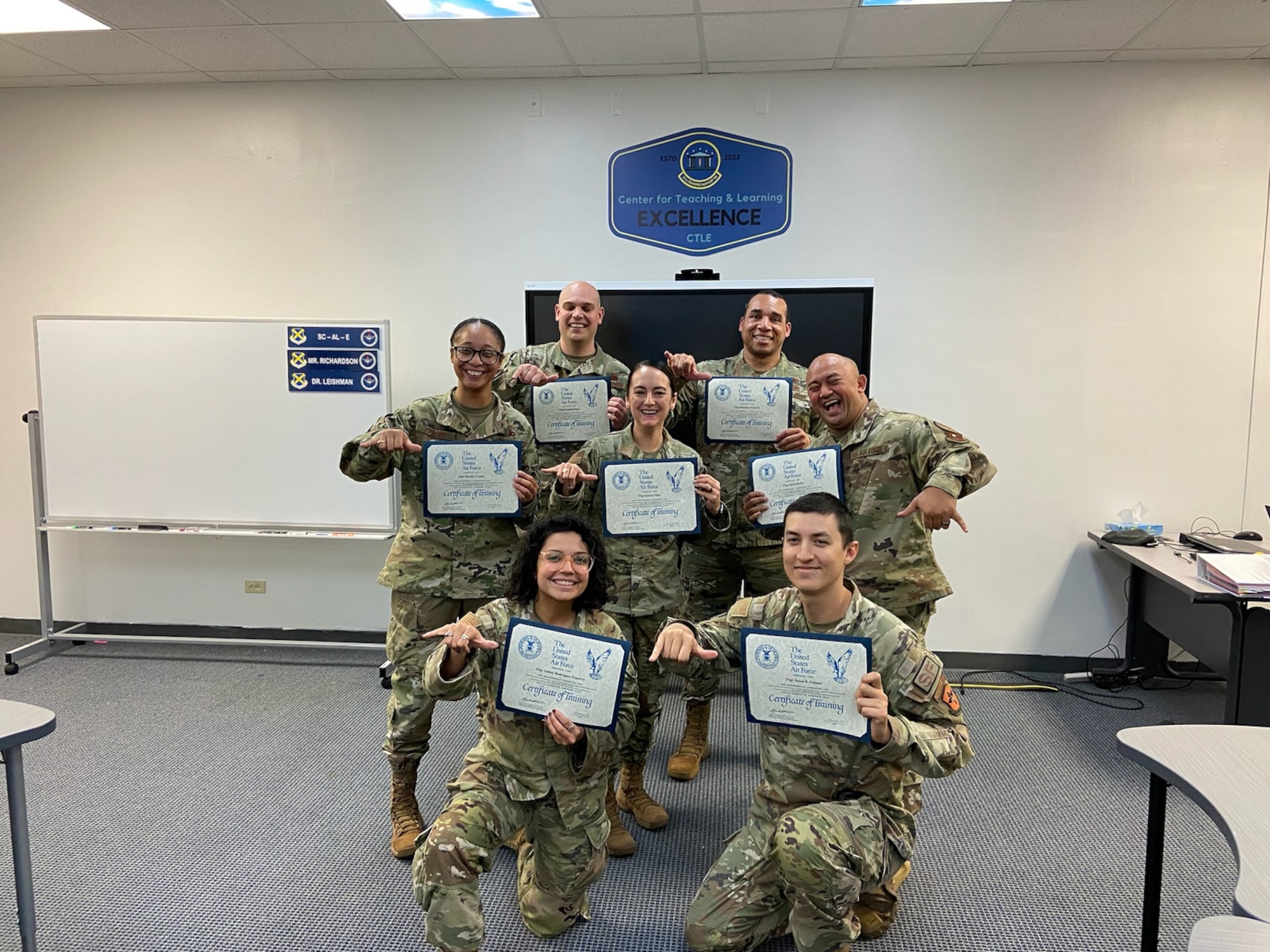 A group of people holding certificates