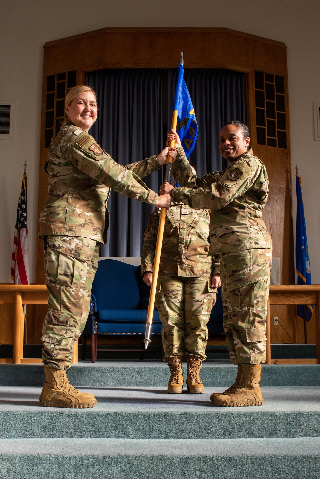 Col. Brande Newsome accepts the guidon flag of the 914th Aeromedical Staging Squadron, thereby taking command of the unit.