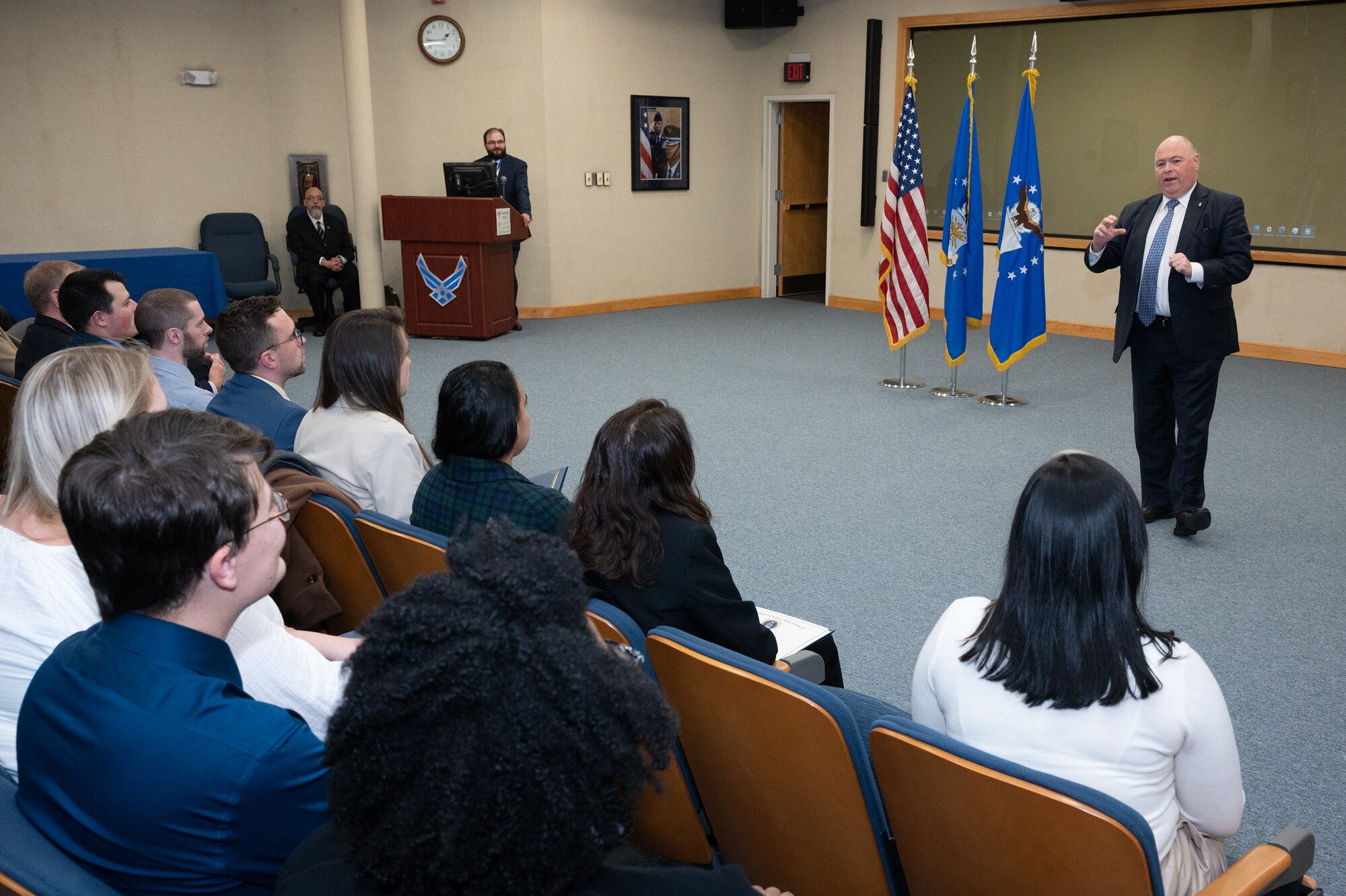 Joe Bradley, director of the Cyber Resiliency Office for Weapons Systems, and associate director of Engineering and Technical Management at Hanscom Air Force Base, Mass., speaks to new Air Force Life Cycle Management Center and Air Force Nuclear Weapons Center civilian employees during their cross-
functional graduation ceremony at Hanscom Air Force Base, Mass., Dec. 8. Many of the 58 new program managers, logisticians, contracting officers, and engineers attended the graduation ceremony either virtually or in-person. (U.S. Air Force photo by Todd Maki.)