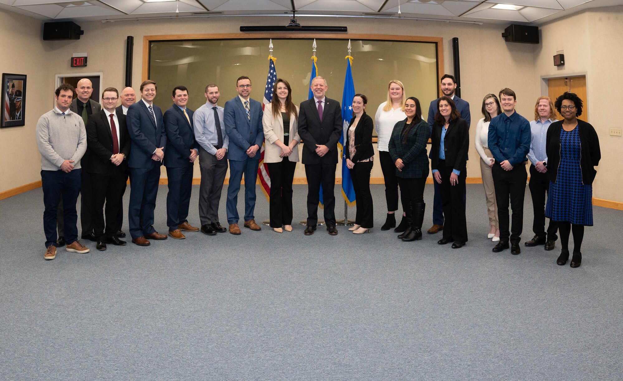 Scott Hardiman, Air Force Nuclear Weapons Center director for Nuclear Command, Control and Communications (NC3) Integration and Air Force program executive officer for NC3, center, joins new Air Force Life Cycle Management Center and Air Force Nuclear Weapons Center civilian employees pose for a photo following their training program graduation ceremony at Hanscom Air Force Base, Mass., Dec. 8. Fifty eight program managers, logisticians, contracting officers, and engineers completed two- and three-year training programs that provided a combination of virtual and in-person classroom and on-the-job training. (U.S. Air Force photo by Todd Maki.)