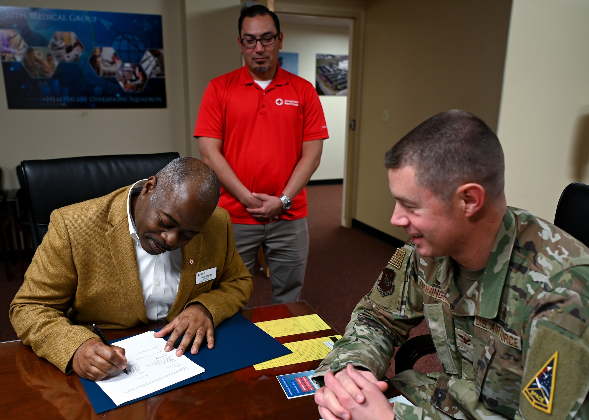 Col. Brent Cunningham, 30th Medical Group commander, meets with Tony Briggs, American Red Cross regional chief executive officer, to sign the Memorandum of Understanding, Dec. 16, 2022 at Vandenberg Space Force Base, Calif. This joint endeavor provides a platform to bring in civilian volunteers and present a possible opportunity for these volunteers to be hired as permanent medical staff members of the 30th Medical Group. (U.S. Space Force photo by Airman 1st Class Tiarra Sibley)