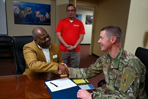 Col. Brent Cunningham, 30th Medical Group commander, meets with Tony Briggs, American Red Cross regional chief executive officer, to sign the Memorandum of Understanding, Dec. 16, 2022 at Vandenberg Space Force Base, Calif. The signing of this Memorandum of Understanding will bridge the gap between Vandenberg Space Force Base and the local community. (U.S. Space Force photo by Airman 1st Class Tiarra Sibley)