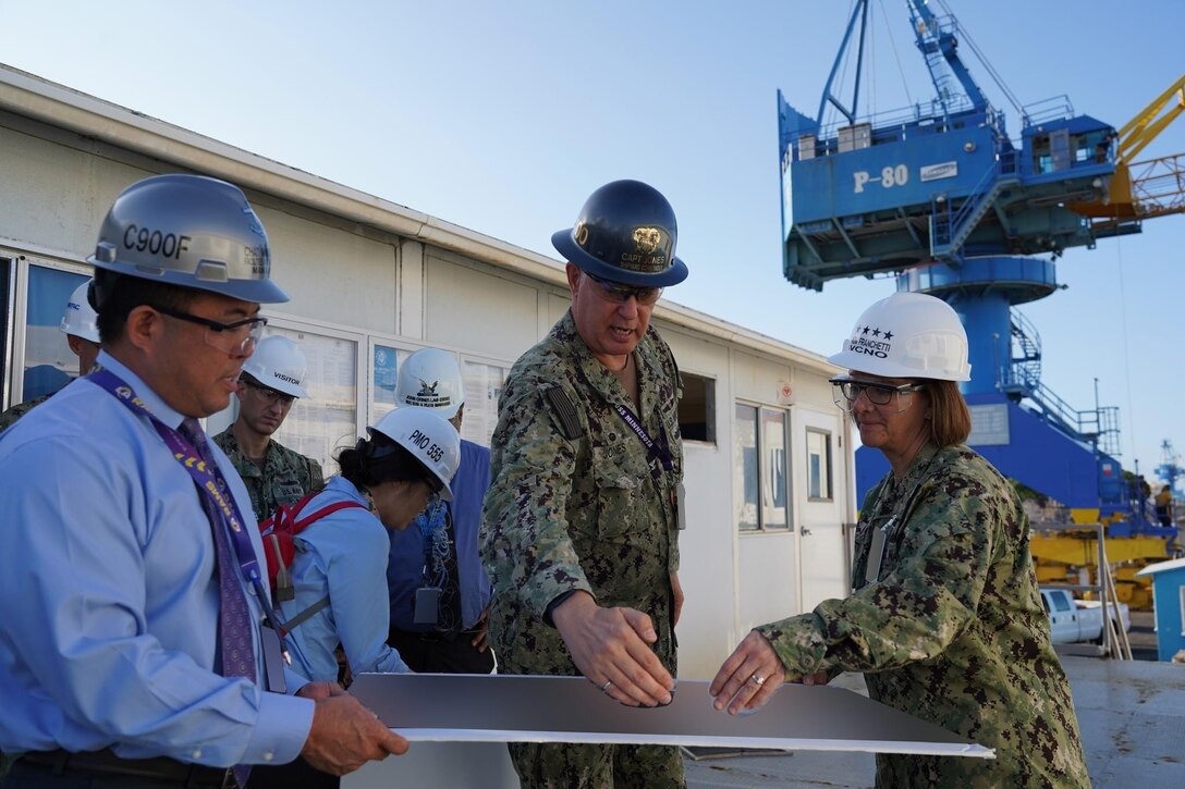 PEARL HARBOR, Hawaii (December 14, 2022) Vice Chief of Naval Operations Admiral Lisa Franchetti meets with a shipyard worker at Pearl Harbor Naval Shipyard & Intermediate Maintenance Facility (PHNSY & IMF) during a visit for an operations update and Shipyard Infrastructure Optimization Program (SIOP) tour onboard Joint Base Pearl Harbor-Hickam.