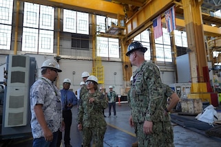 PEARL HARBOR, Hawaii (December 14, 2022) Vice Chief of Naval Operations Admiral Lisa Franchetti meets with a shipyard worker at Pearl Harbor Naval Shipyard & Intermediate Maintenance Facility (PHNSY & IMF) during a visit for an operations update and Shipyard Infrastructure Optimization Program (SIOP) tour onboard Joint Base Pearl Harbor-Hickam.