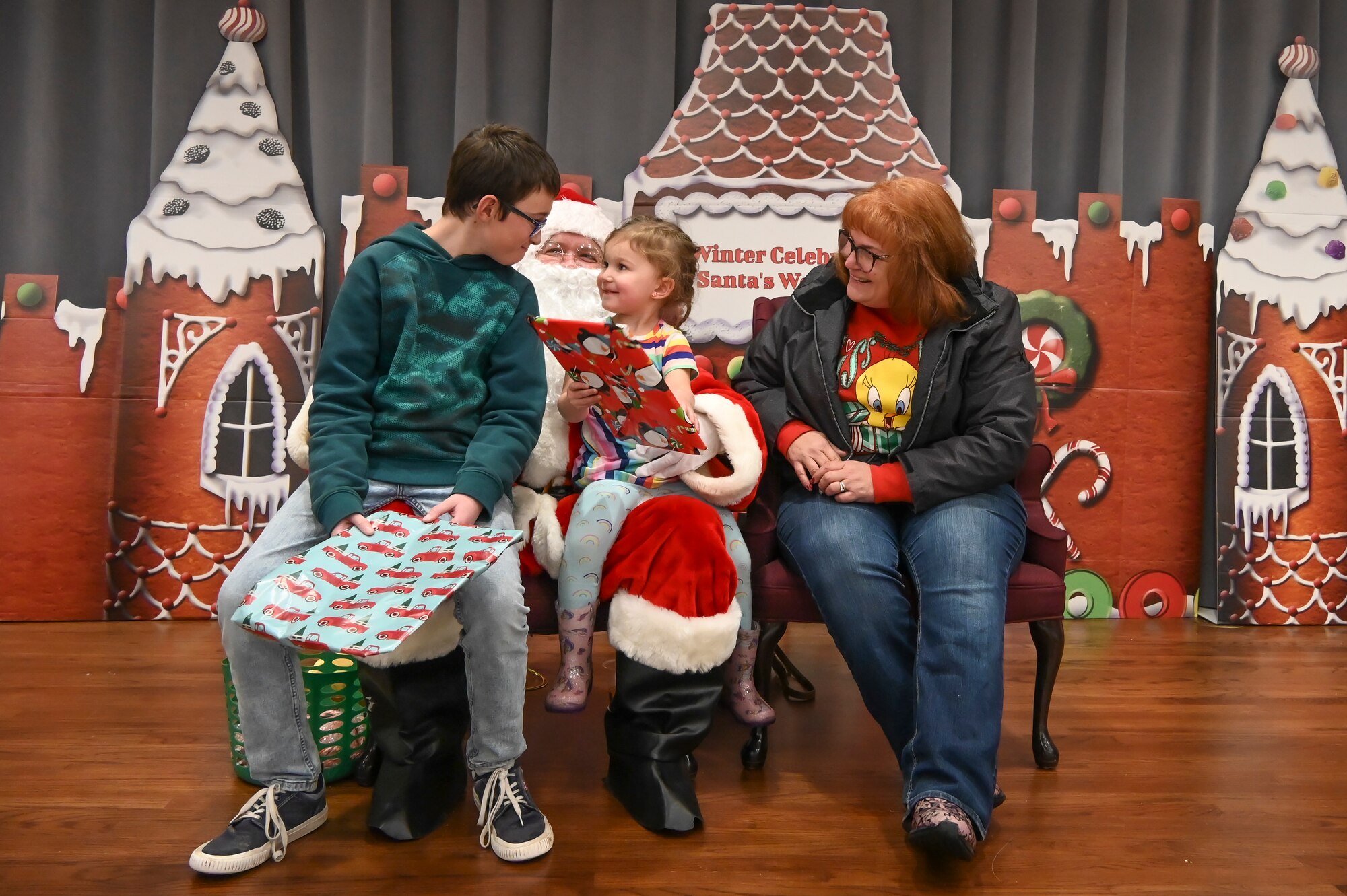 Children sit with santa.