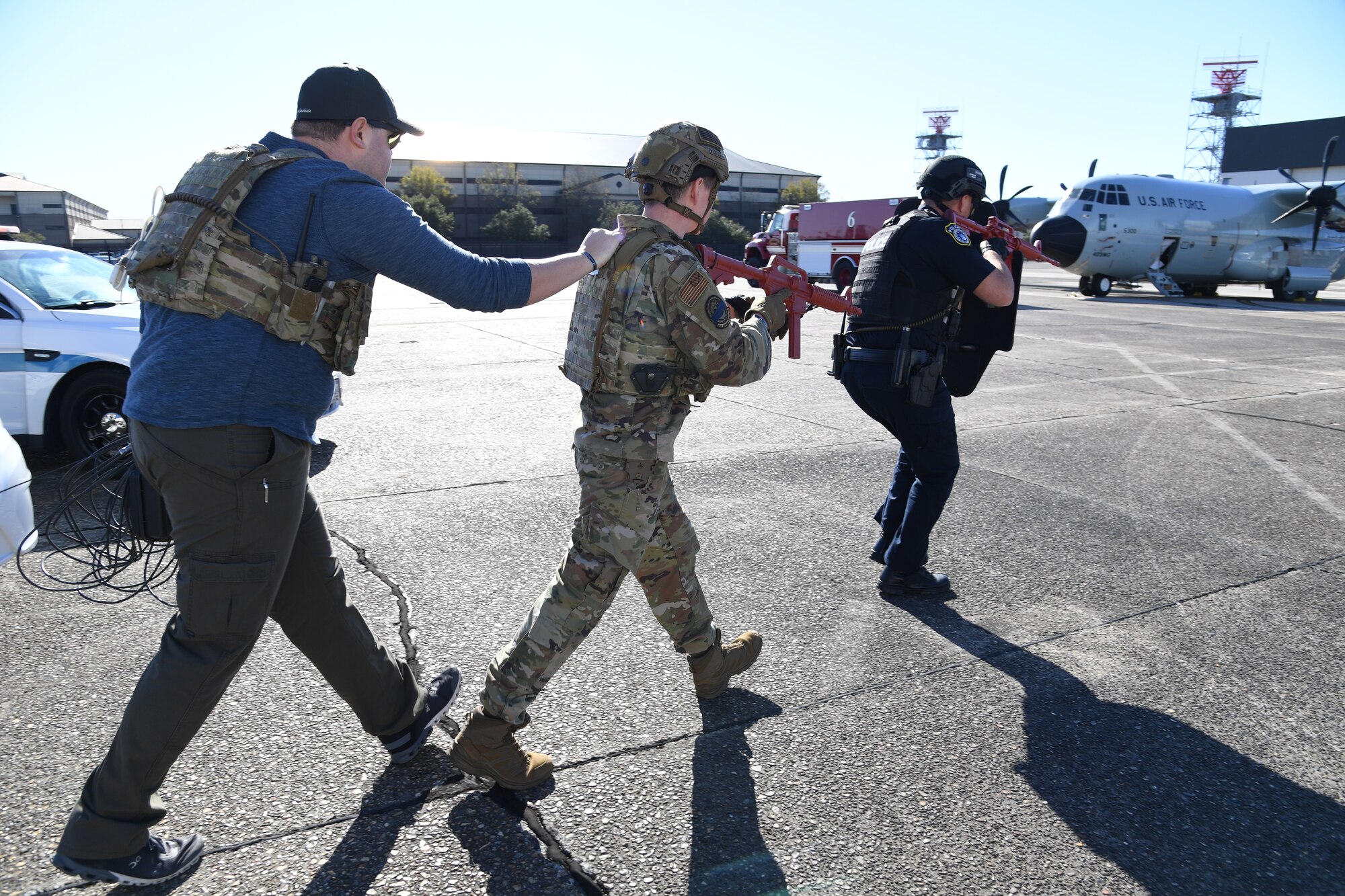 Members of the 81st Security Forces Squadron engage the aircraft to drop a phone for negotiations during a hijacking exercise at Keesler Air Force Base, Mississippi, Dec. 15, 2022.