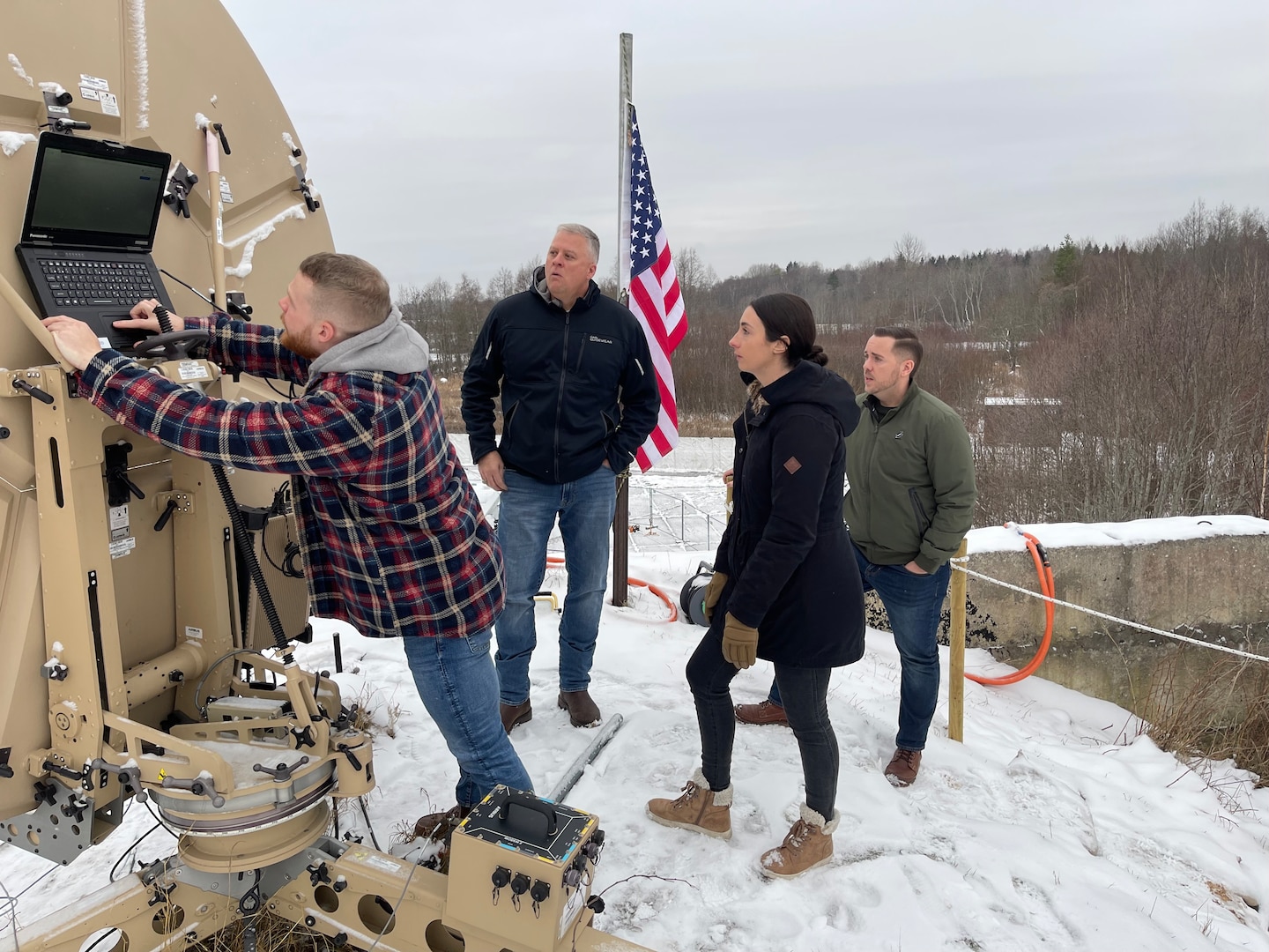 From their Forward Operating Base, 16th Air Force Airmen U.S. Air Force Senior Airman Austin Lesperance,  Staff Sgt. Katelyn Hartman and, Staff Sgt. Chad Hartman, from the 67th Cyber Operations Group, brief Brig. Gen. Jeffrey Hill (second from left), 16th Air Force mobilization assistant to the 16th Air Force commander, on their mission supporting Estonian Defense Forces. Hill visited them during his trip representing the U.S. at NATO Exercise, Cyber Coalition 2022. (U.S. Air Force photo by Lt. Col. Harry “Rican” Jimenez)